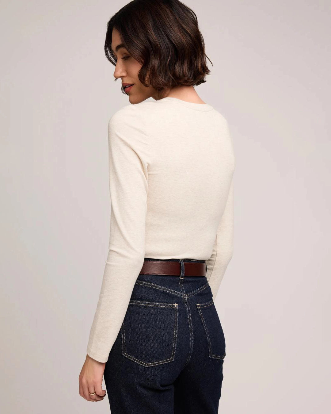 Woman wearing a cream long sleeve top