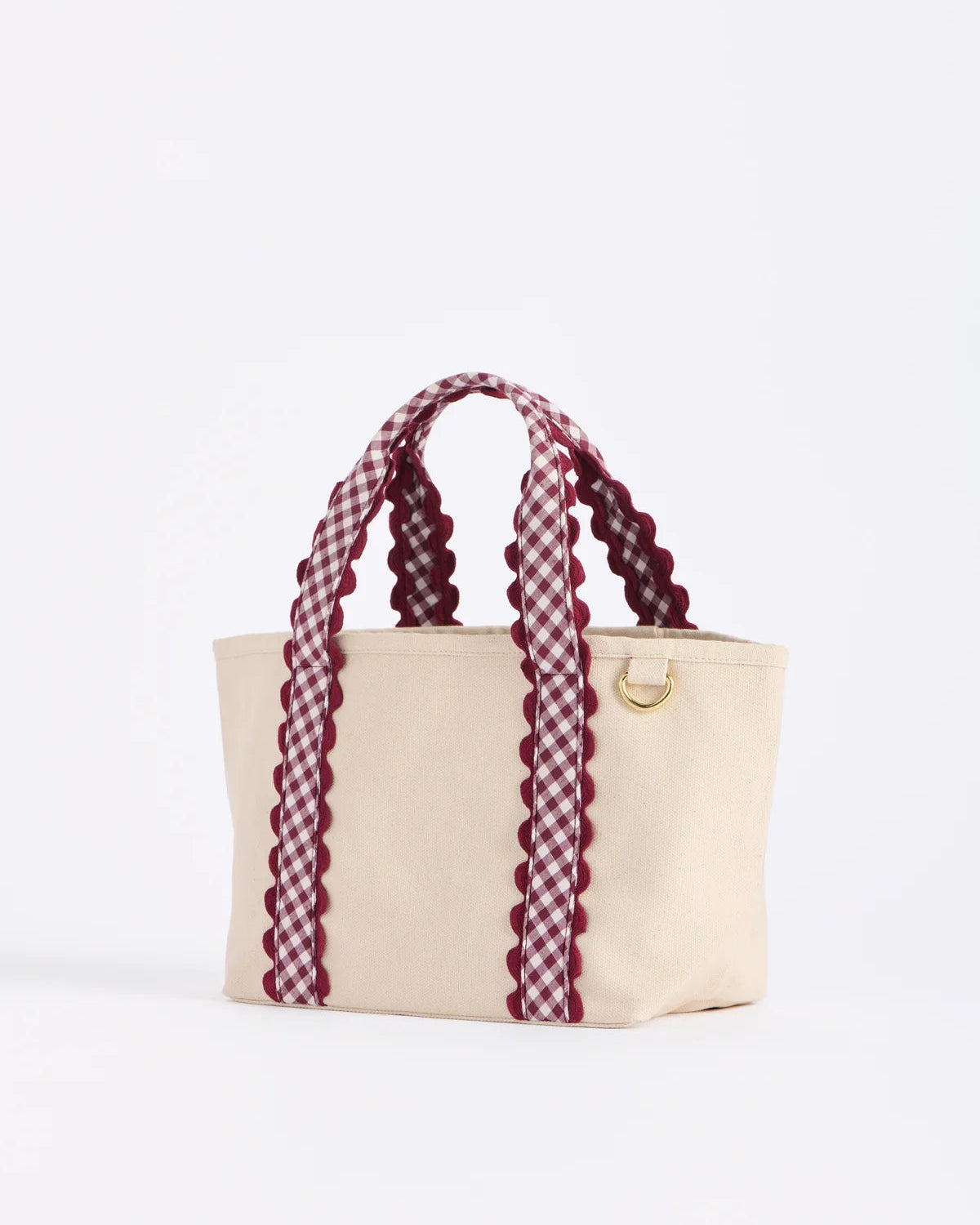 cream mini tote bag with red plaid strap
