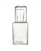 a picture of a glass water decanter with a cup that acts as a lid