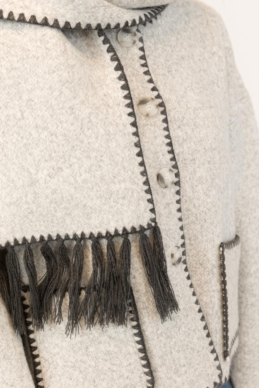 Close-up of a light grey coat with scarf 