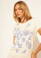 cream t-shirt with blue outlines of ocean finds