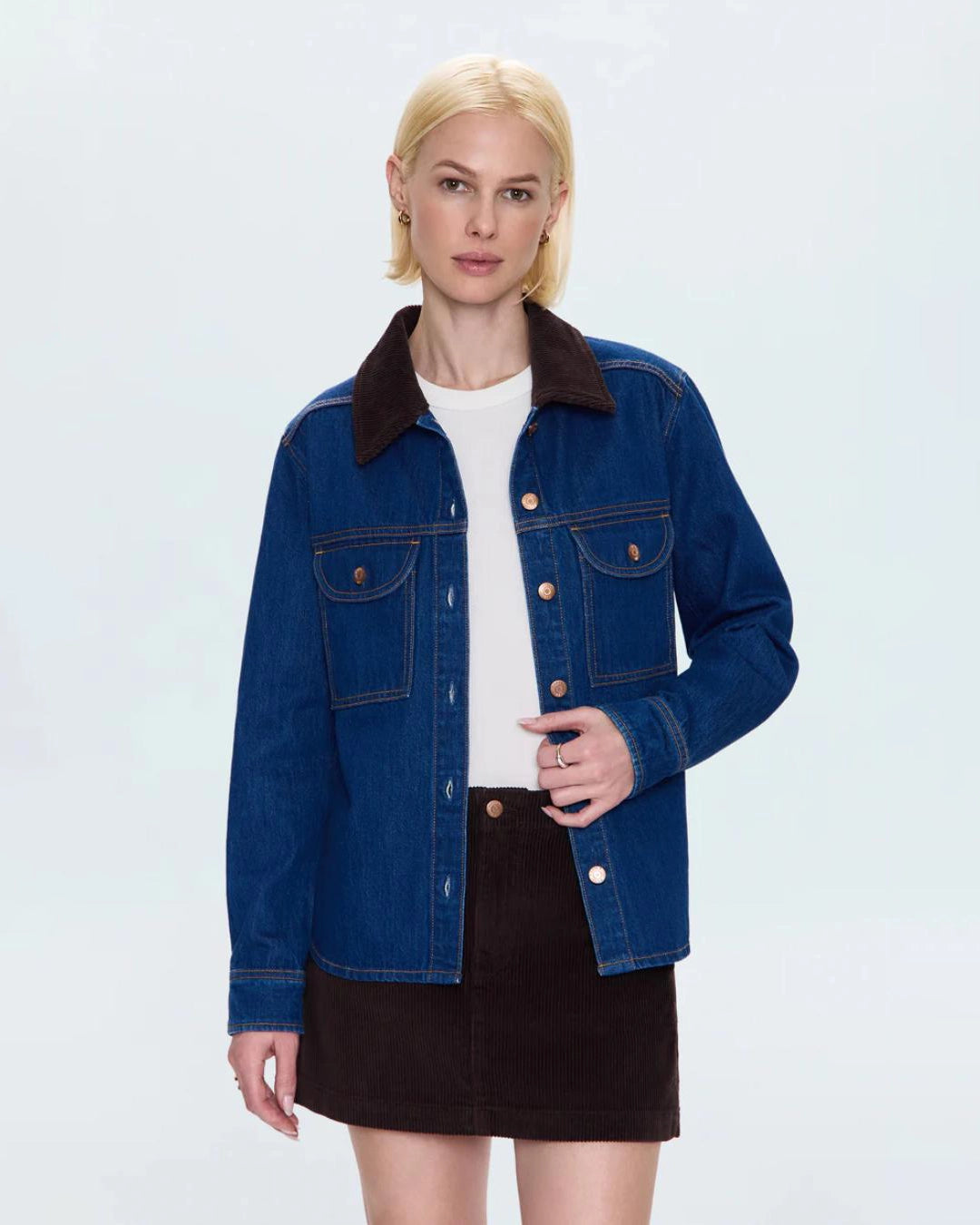 a woman wears a relaxed denim jacket with brown corduroy collar detail