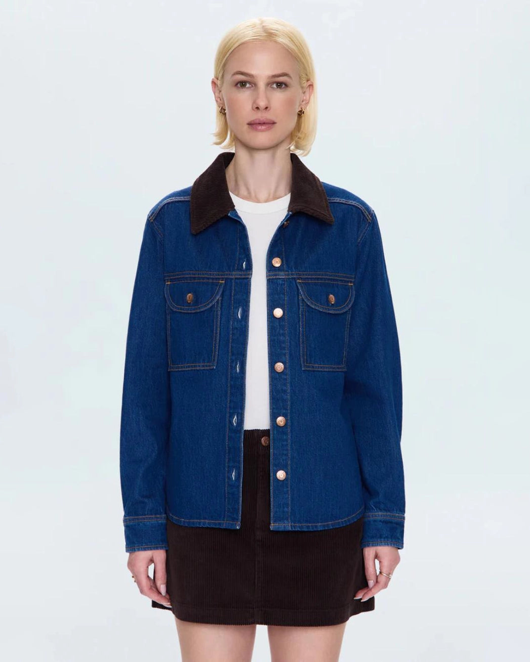 a woman wears a relaxed denim jacket with brown corduroy collar detail
