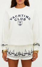 white lounge shorts with navy sailboats on the bottom 