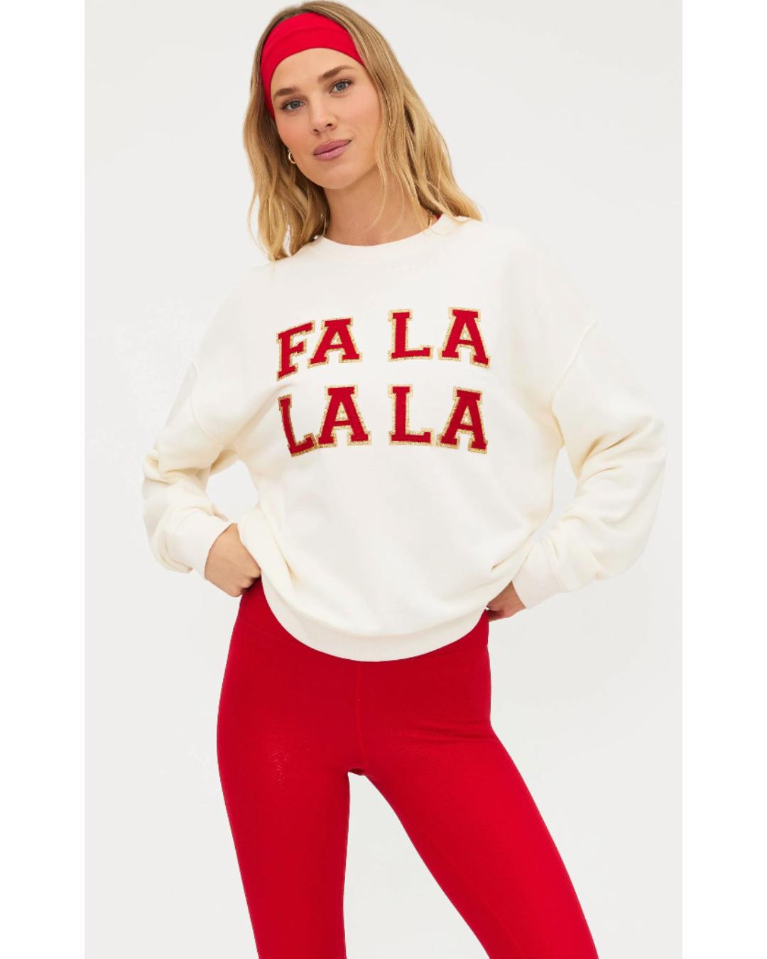 cream sweatshirt with "falala" in red text