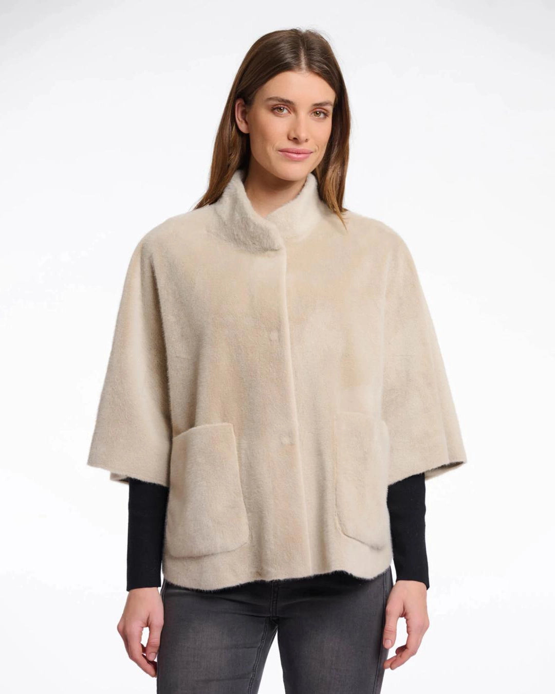 Woman wearing a beige faux fur cape in beige