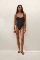 black onepiece swimsuit with cream polka dots