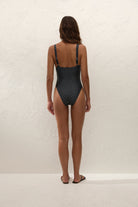 black onepiece swimsuit with cream polka dots