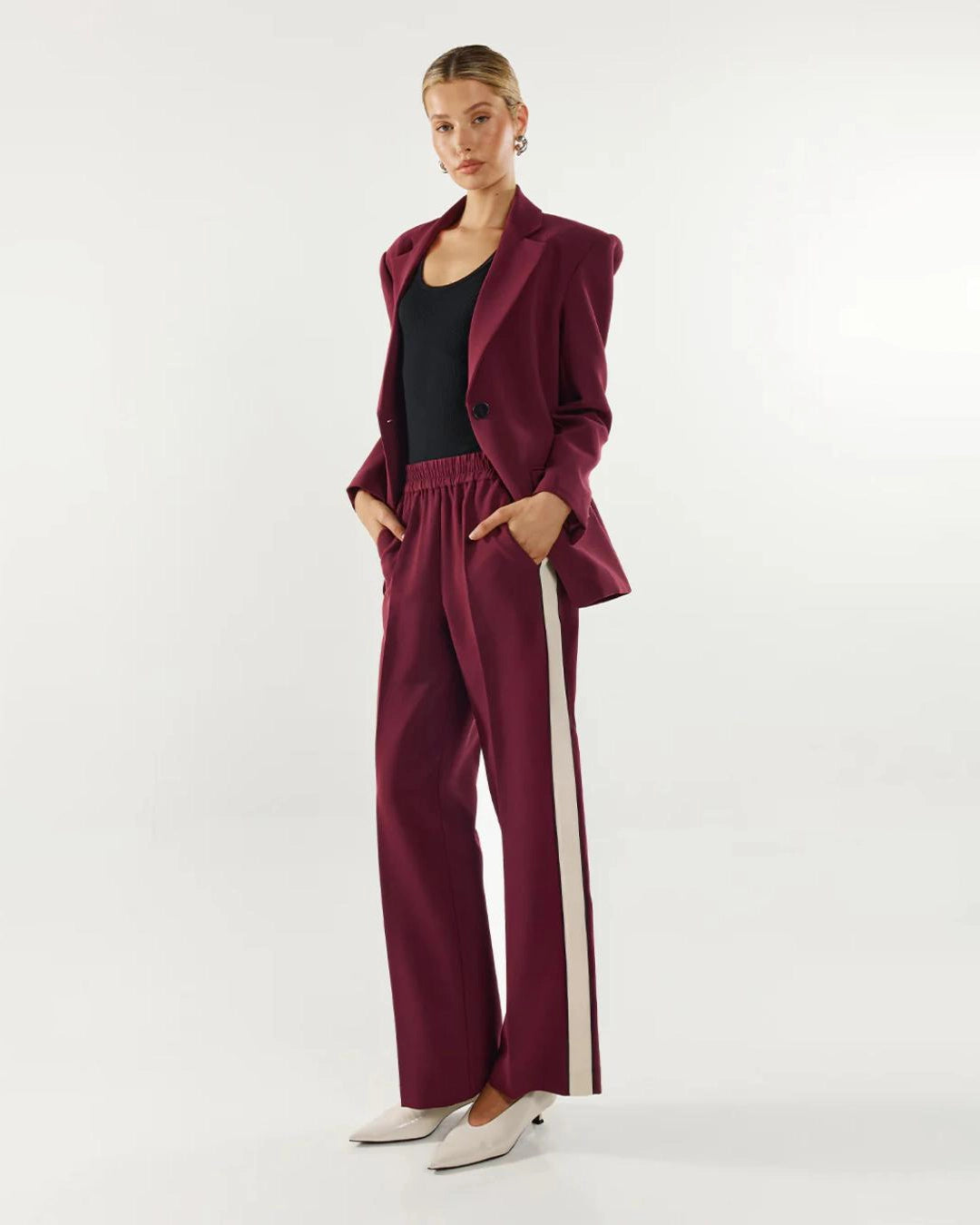 Woman wearing a burgundy suit blazer