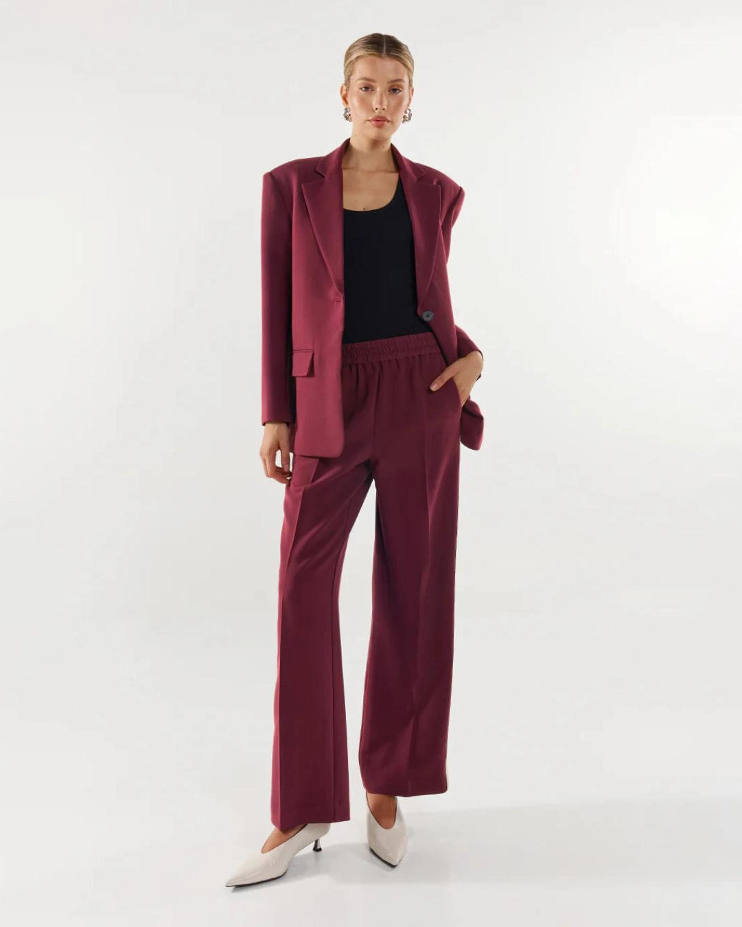 Woman wearing a burgundy suit blazer