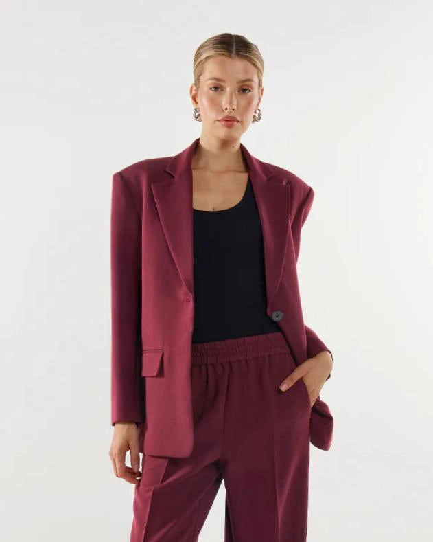 Woman wearing a burgundy suit blazer