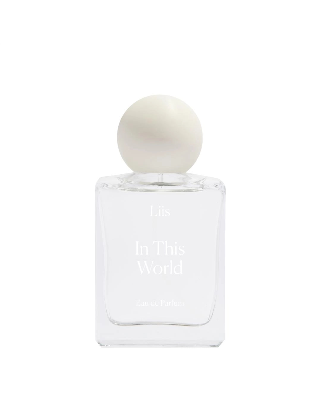 Perfume bottle and packaging with 'In This World' branding on a white background