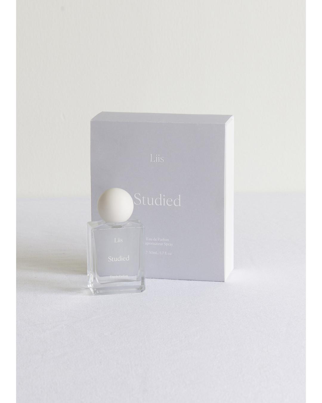Perfume bottle with packaging labeled 'Studled' on a white background