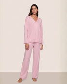 a woman wears pale pink modal pajamas by eberjey