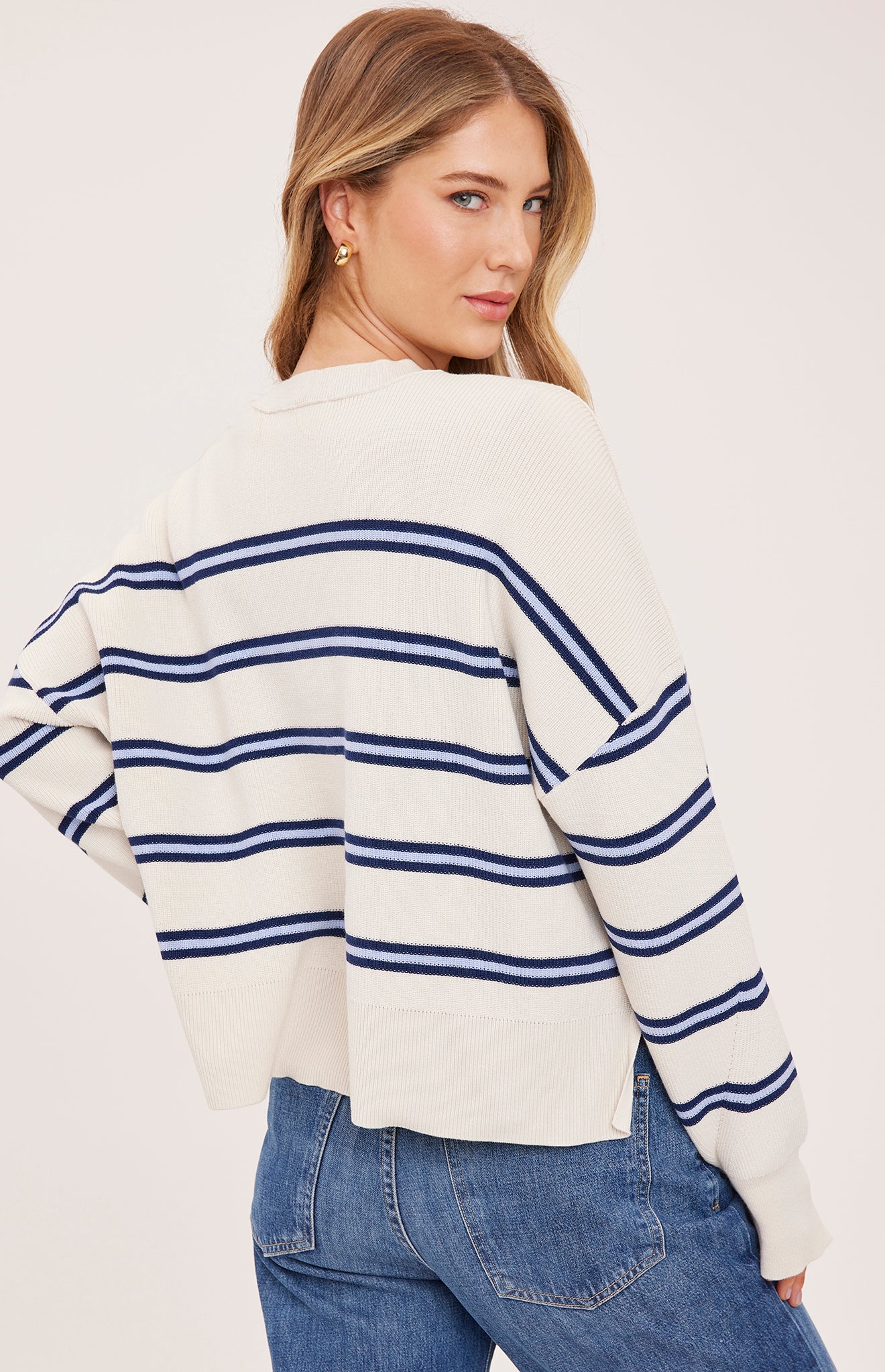cream sweater with a dark and light blue stripe