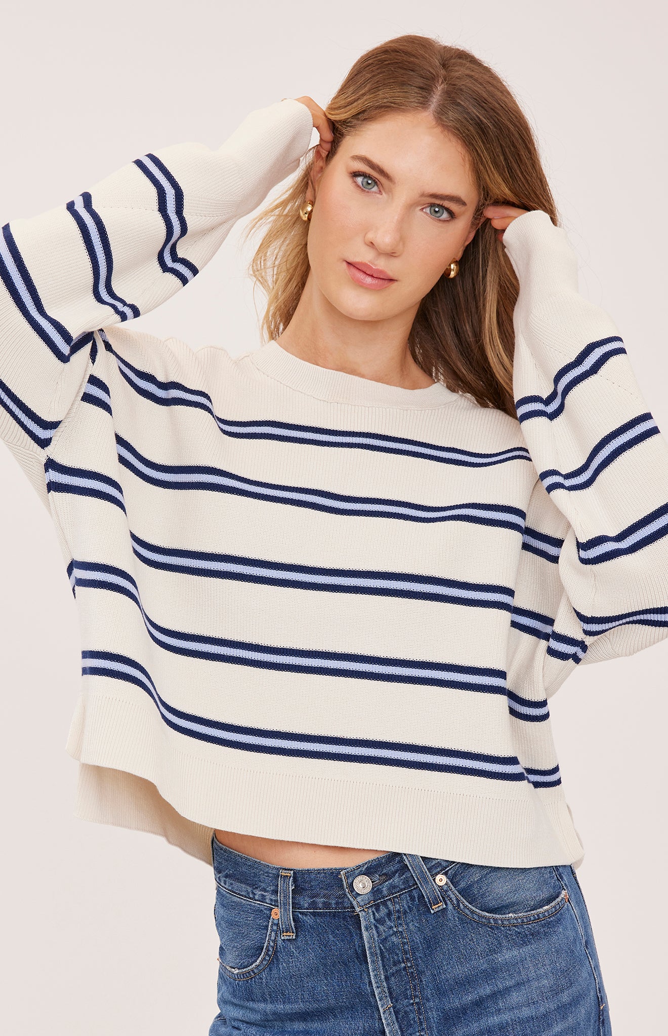 cream sweater with a dark and light blue stripe