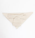 beige knit beanie laid down with matching scarf and mitts