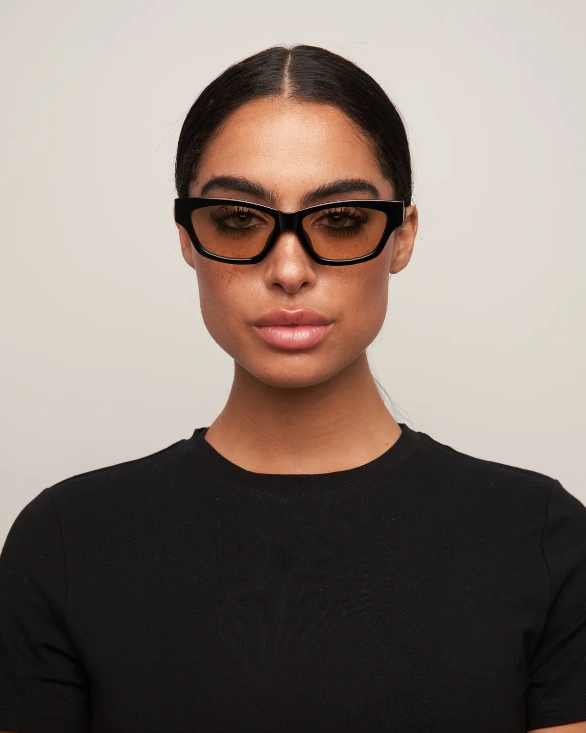 cat eye statement sunglasses with black frame and brown lenses 
