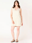 mini dress that has an embroidered pattern in off white
