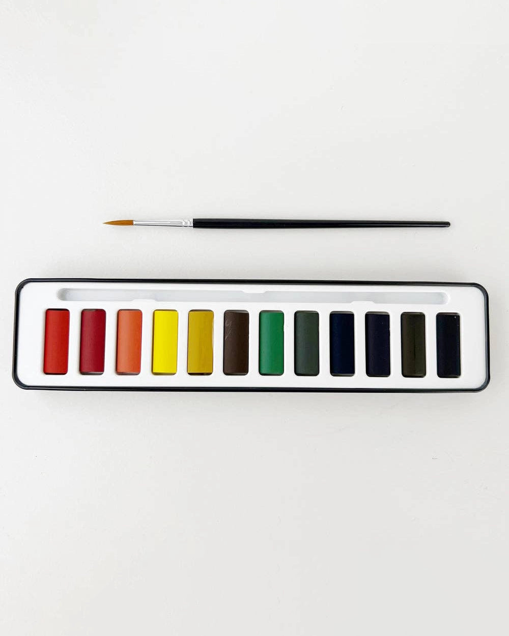 Set of watercolour paints with a brush and open case and swatches