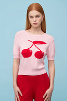 pink short sleeve sweater with red cherries on the front