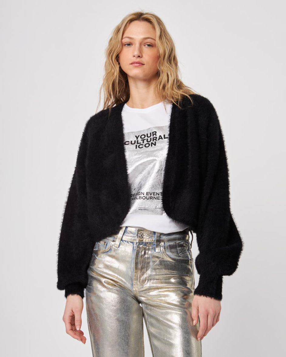 Woman wearing a black fluffy cardigan shrug