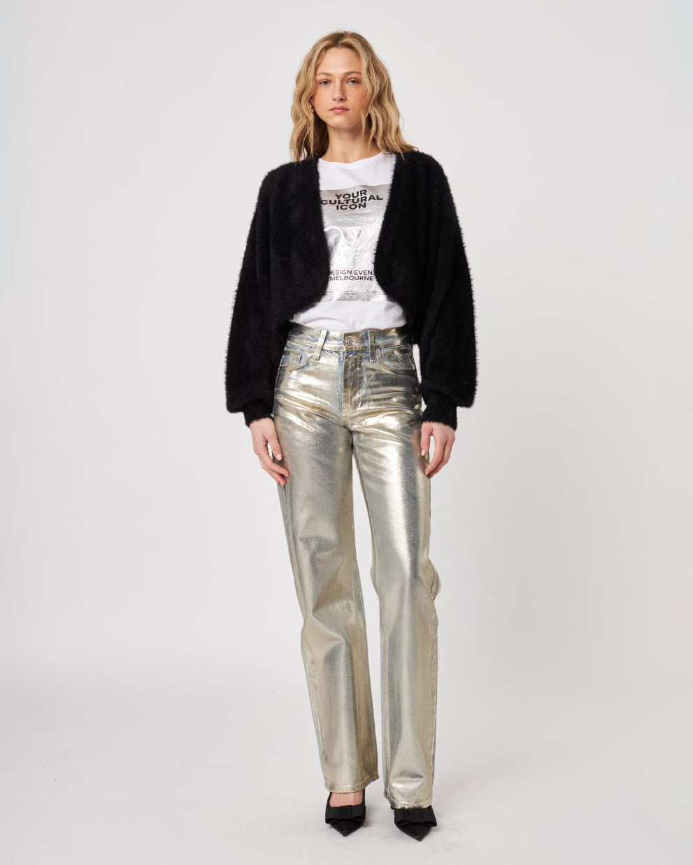 Woman wearing a black fluffy cardigan shrug