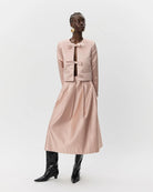 pink blazer jacket with two bows holding it together