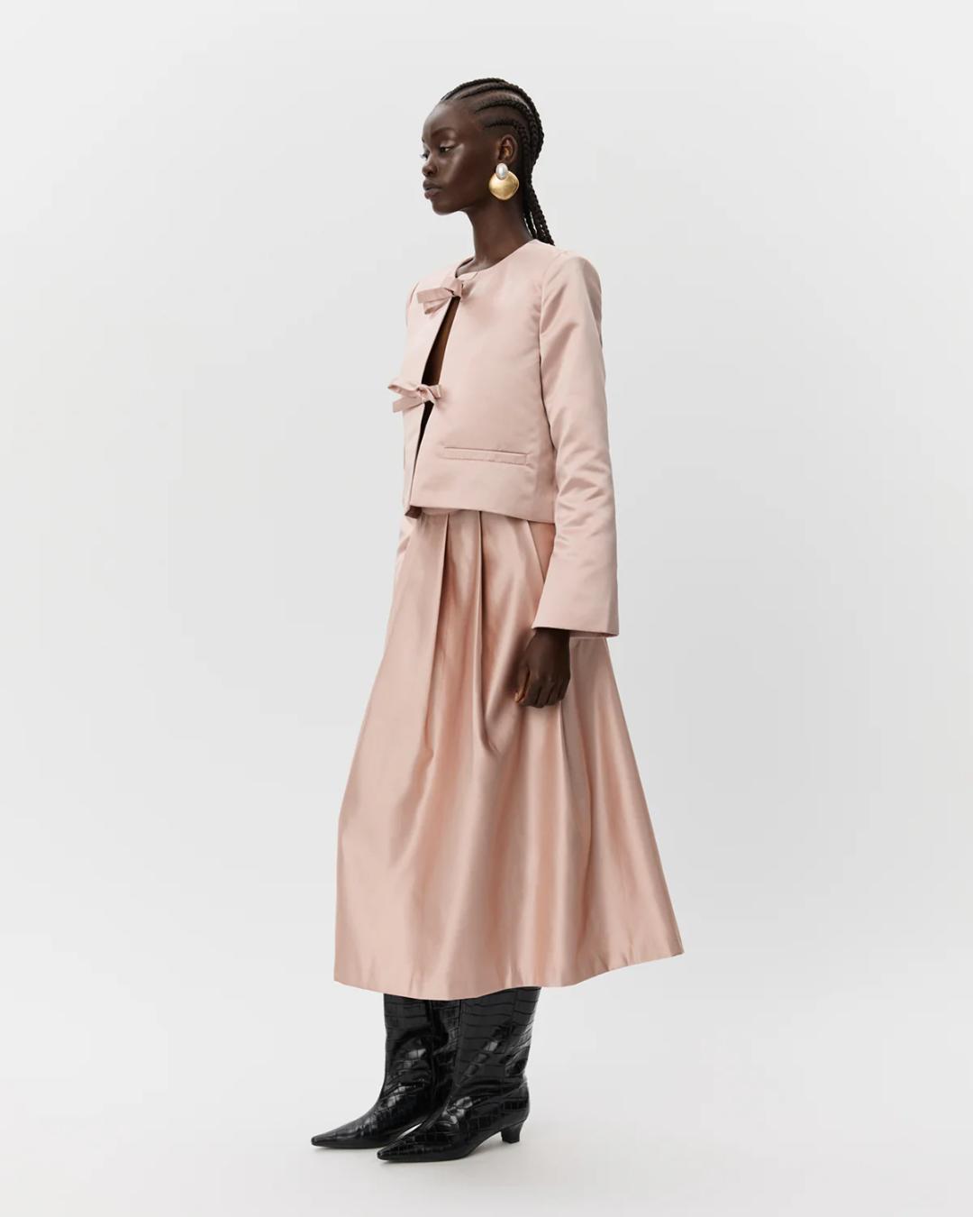 pink blazer jacket with two bows holding it together