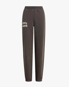 dark brown sweatpants with 'favourite daughter' in varsity letters on them 