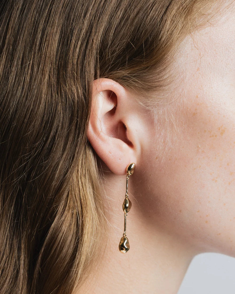 gold bean shaped drop earrings