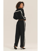 black crewneck sweatshirt with a white stripe across the back and arms