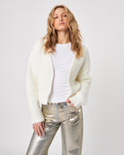 Woman wearing a white fluffy knit cardigan