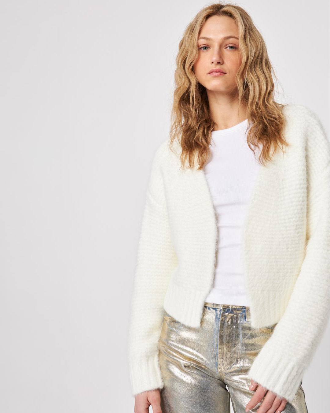 Woman wearing a white fluffy knit cardigan