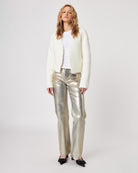 Woman wearing a white fluffy knit cardigan