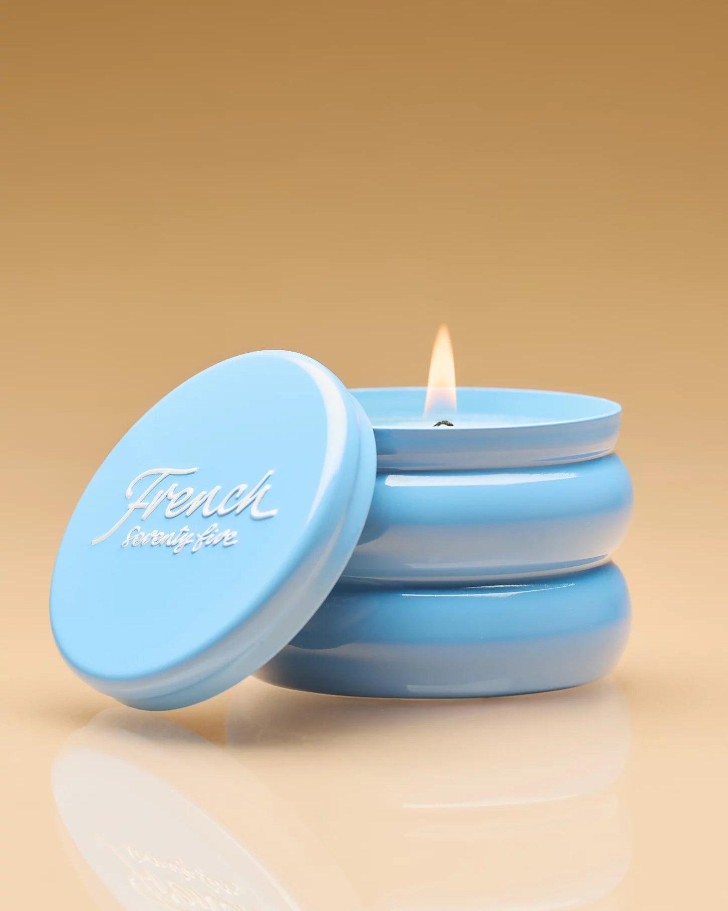 candle in blue tin