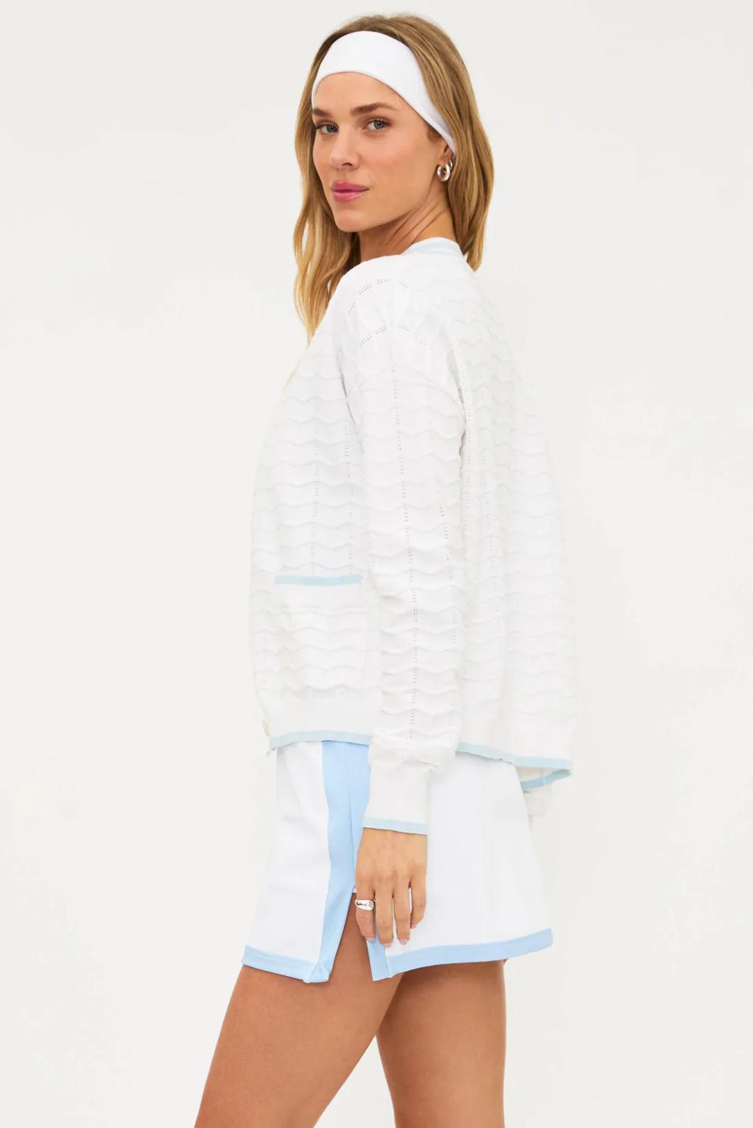 white v-neck cardigan with blue stripes down middle and pockets