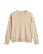 beige knit sweater with lace trim on bottom