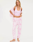 Woman wearing a pink and white toile floral outfit