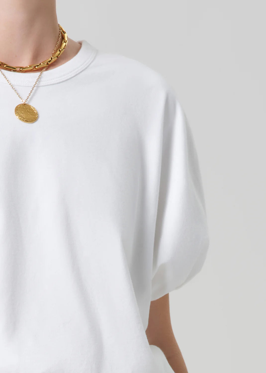 white cropped short sleeve top with a bubble waist and sleeve