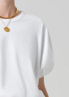 white cropped short sleeve top with a bubble waist and sleeve