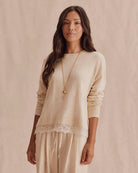 beige knit sweater with lace trim on bottom