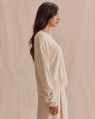 beige knit sweater with lace trim on bottom