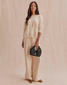 beige knit sweater with lace trim on bottom