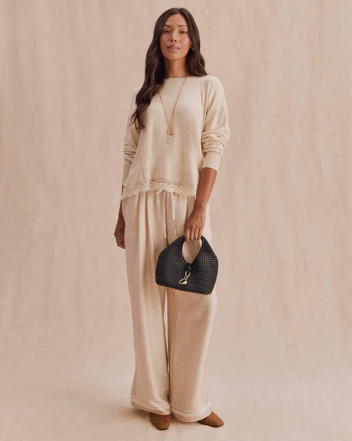 beige knit sweater with lace trim on bottom