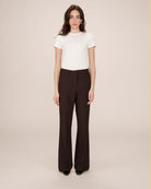 woman wearing brown tailored wide leg pants and white tee
