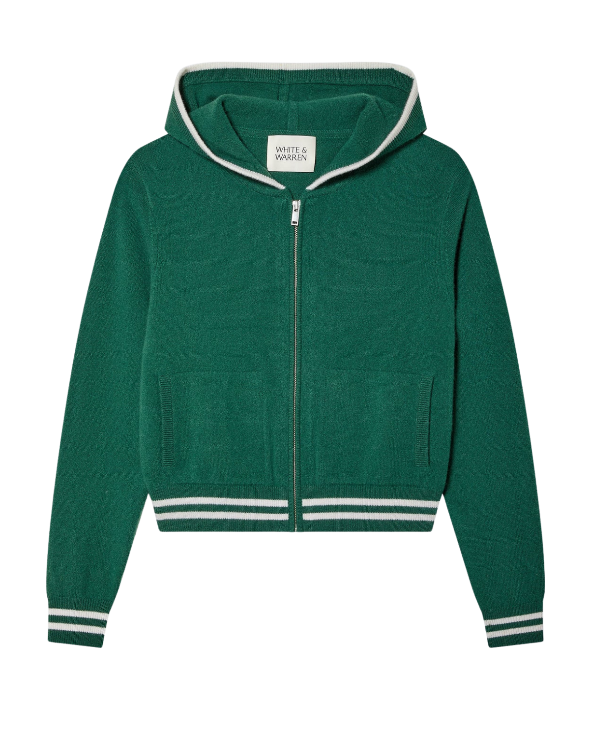 A woman wears a green varsity tracksuit style zip up hoodie with white stripes and matching shorts
