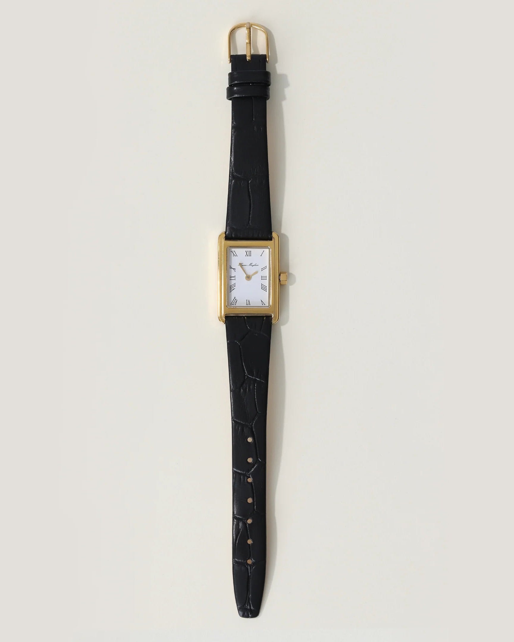 wrist watch with a black leather strap and gold and white face