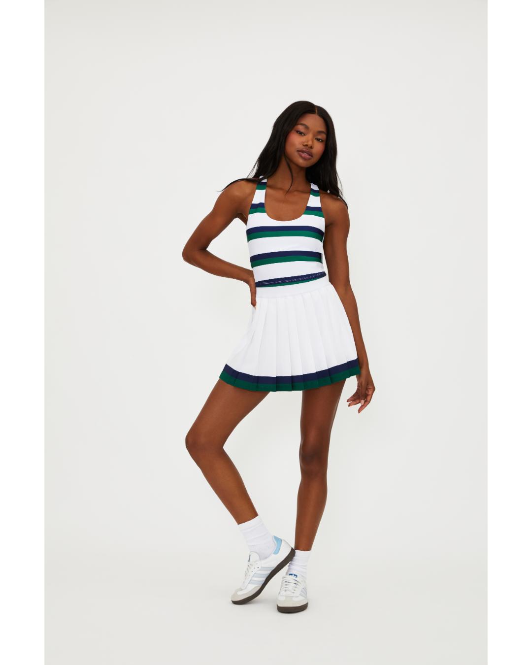 white pleated tennis skirt with navy and green stripe around the bottom