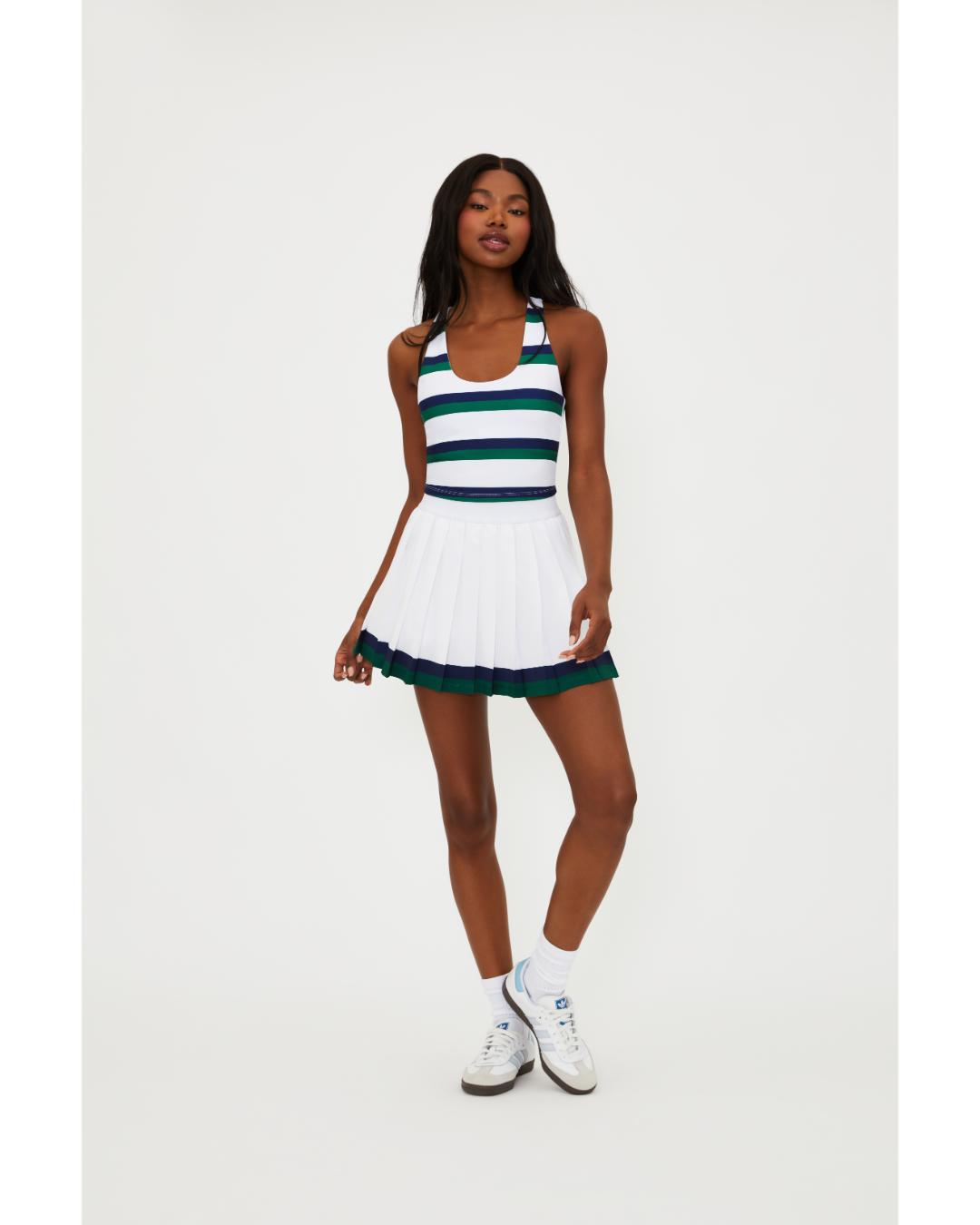 white pleated tennis skirt with navy and green stripe around the bottom